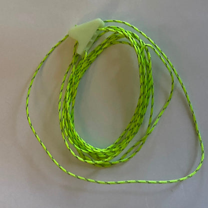 Coiled strands of bright neon green braided guyline cord with glow in the dark line locks, placed on a plain off-white surface.